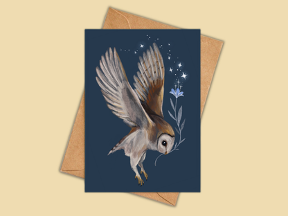 Barn Owl greeting card by Anna Seed: a barn owl in flight carrying a blue flower under the stars on navy