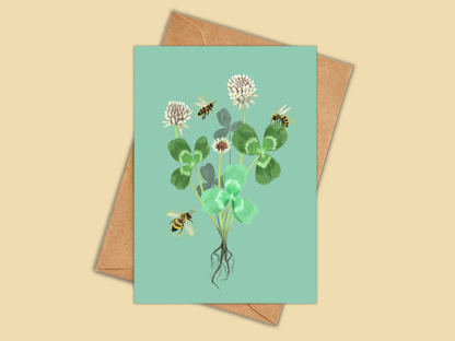 Clover greeting card by Anna Seed: white clover flowers and leaves with honeybees buzzing around, on mint green