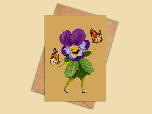Pretty Pansy greeting card by Anna Seed: a dancing purple pansy character with two monarch butterflies, on mustard