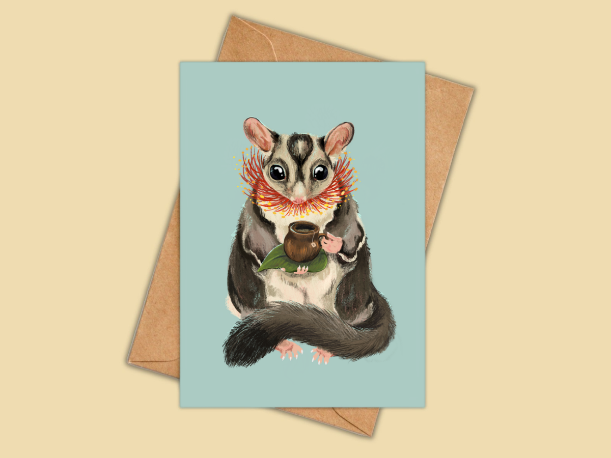 Sugar Glider Teatime greeting card by Anna Seed: a sugar glider with a cup of tea and gum blossom, on pale blue