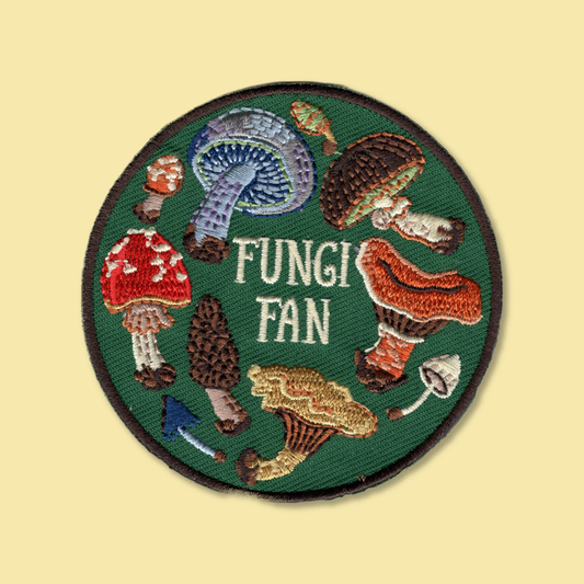 Fungi Fan iron-on patch by Anna Seed: a ring of colourful embroidered mushrooms and toadstools on forest green