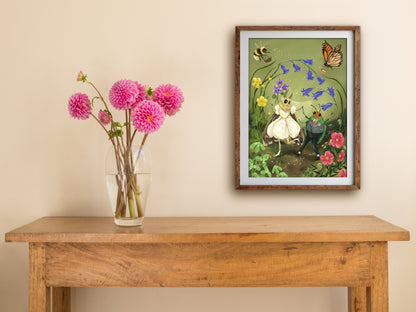 A Wee Wedding print of a moth and beetle wedding, framed on a cream wall above a table with pink dahlias
