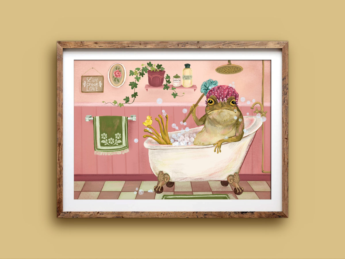 Bath Time art print in a wooden frame, a bubbly toad relaxing in a bath with a rubber duck, on a mustard wall