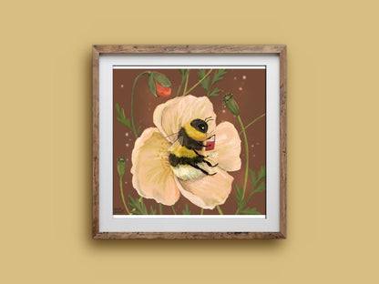 Bee Cosy art print in a wooden frame, a bumblebee curled up reading in a soft peach poppy, on a mustard wall