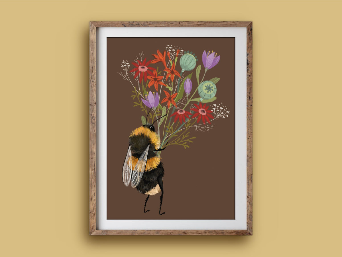 Bee with a Posy art print in a wooden frame, a bumblebee holding a colourful bouquet, on a mustard wall