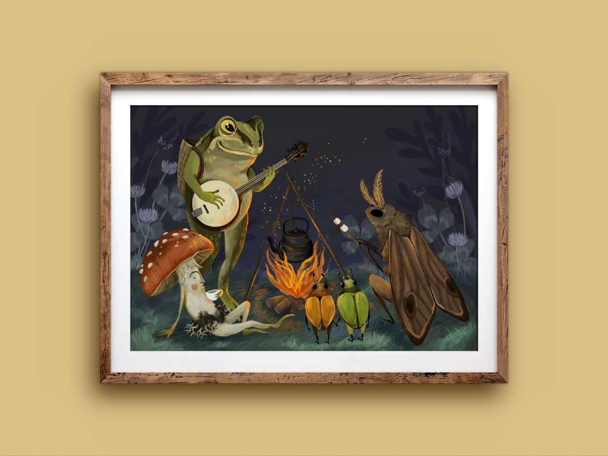 Campfire print in a rustic wooden frame on a mustard wall, showing woodland friends gathered around a fire at night with a banjo