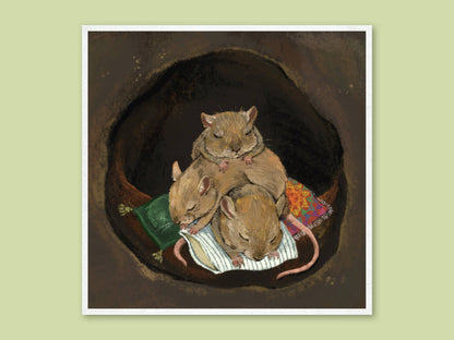 Cuddle Puddle art print by Anna Seed: three field mice asleep in a heap on cushions and blankets inside a dark, cosy burrow