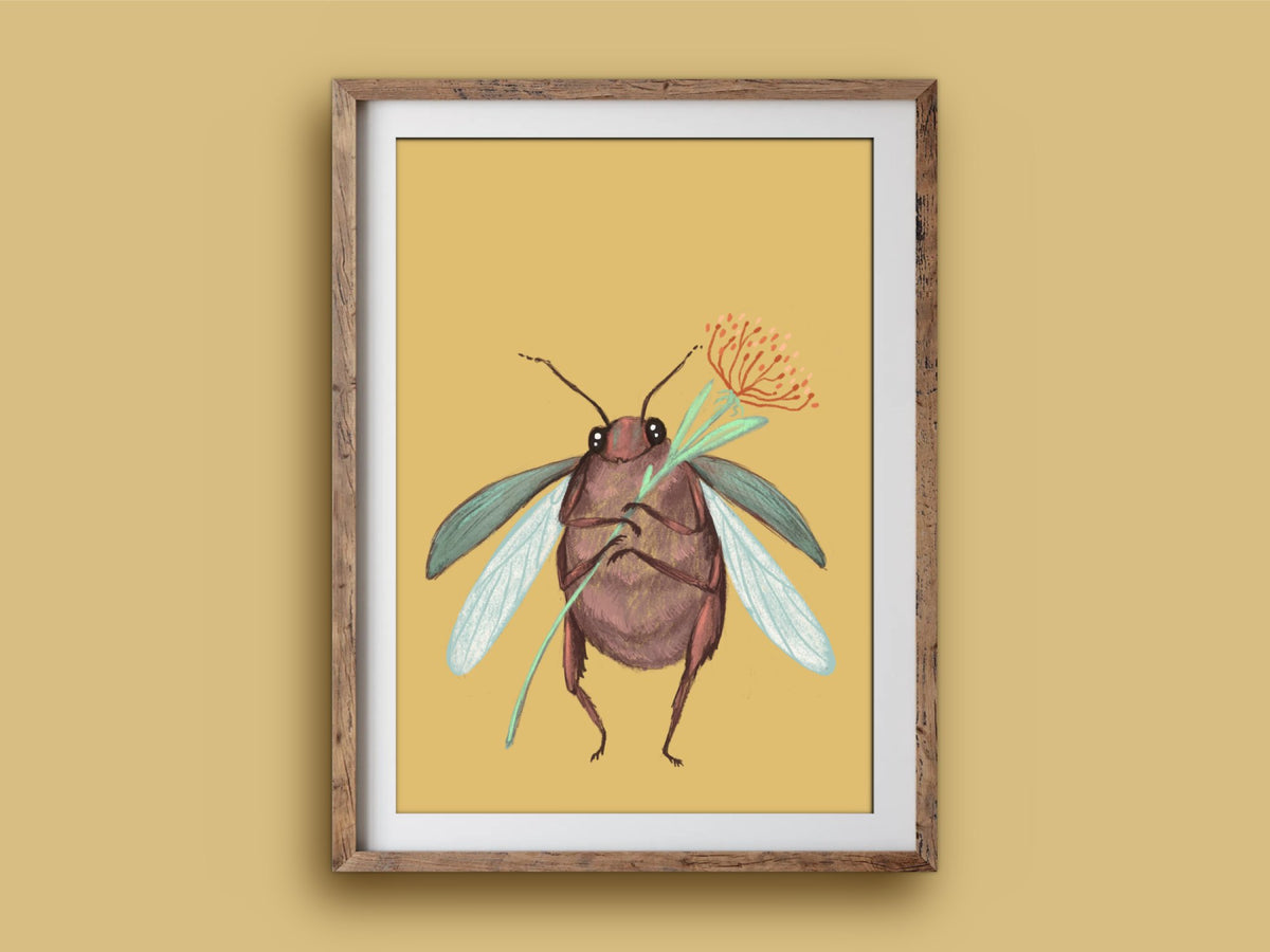 Cute Beetle print in a rustic wooden frame on a mustard wall, showing a winged beetle hugging a little orange flower