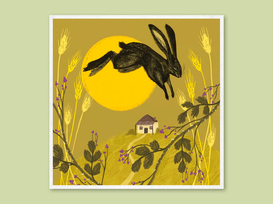 Hare in Summer art print by Anna Seed: a dark hare leaps past a golden sun over a hilltop cottage and wheat stalks