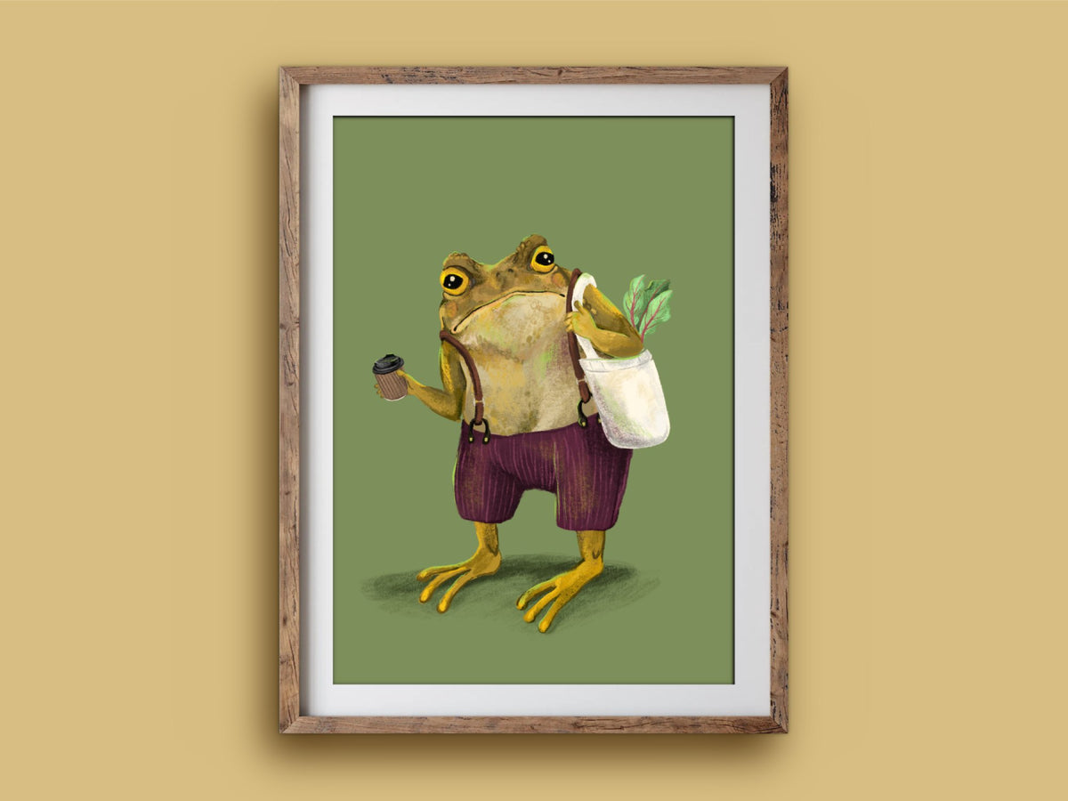 Hipster Toad print in a rustic timber frame: a grumpy toad with a coffee cup and tote of leafy veg on olive green