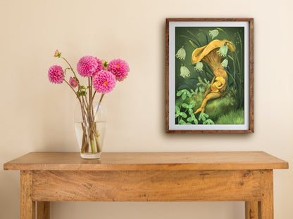 Framed Mushroom Snuggles print hung above a wooden table with pink dahlias, a mushroom mum and baby napping on moss
