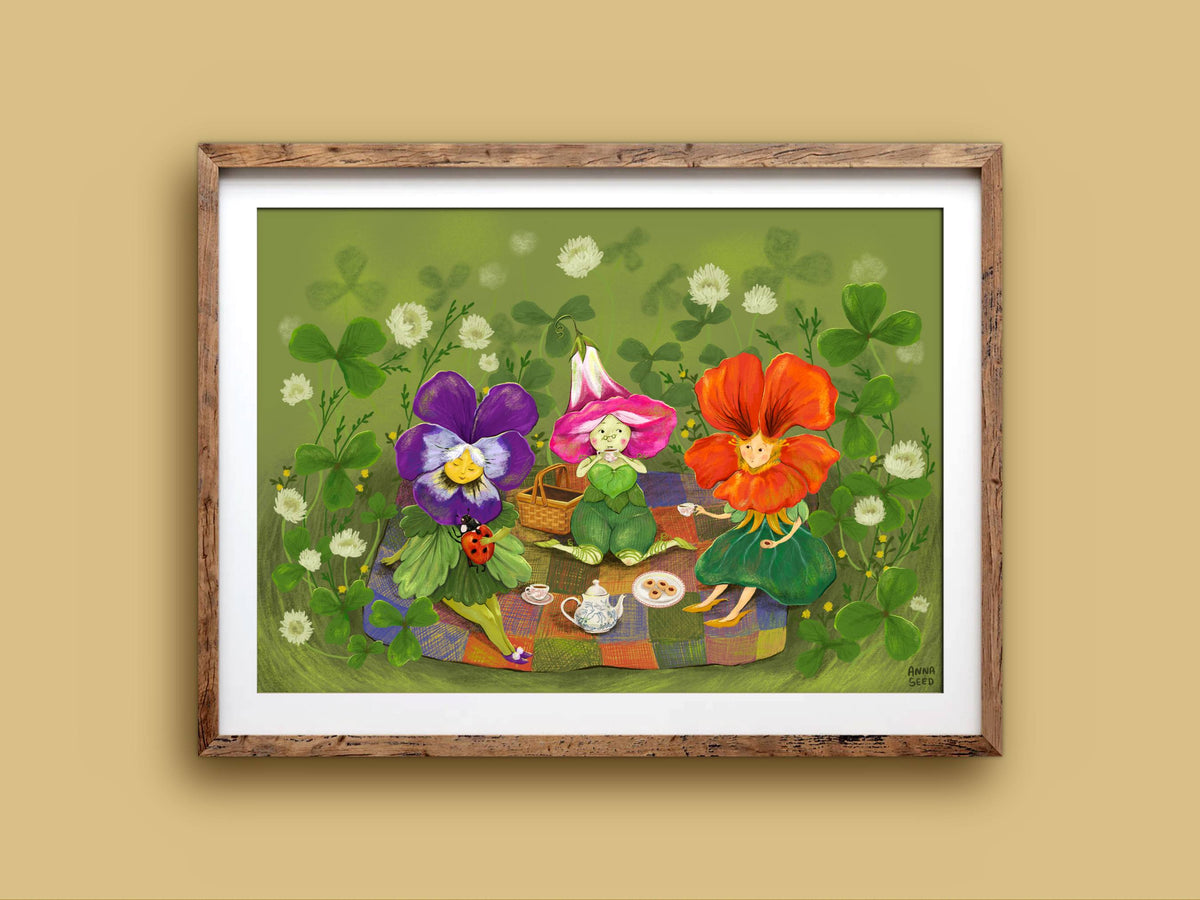 Petal Picnic landscape print in a wooden frame on a mustard wall, flower folk with a teapot, basket and a ladybird