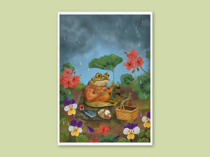Picnic Toad art print by Anna Seed: a toad in an orange jumper sheltering under a leaf at a rainy picnic among pansies