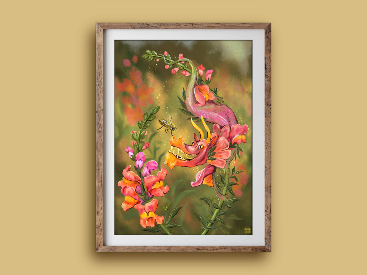 Snapdragon print in a wooden frame on a mustard wall, a smiling flower dragon and bee against a warm, hazy garden