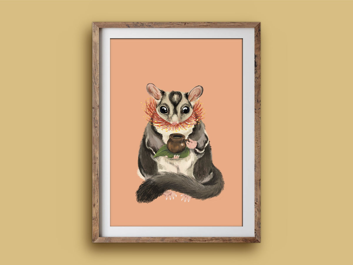 Sugar Glider Teatime print in a wooden frame on a mustard wall, a wide-eyed sugar glider with its gumnut teacup