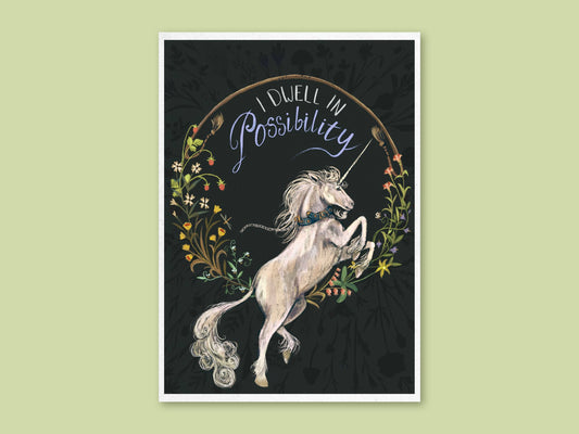 Unicorn art print by Anna Seed: a white medieval-style unicorn rears in a flower wreath under 'I dwell in Possibility', on green