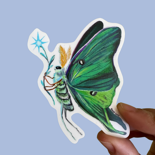 Luna Moth sticker by Anna Seed: a green luna moth holding a blue star flower on a stem, held against a blue backdrop