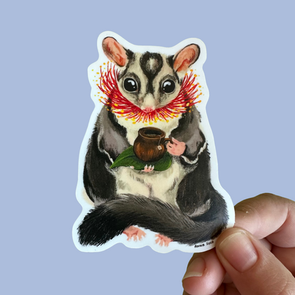 Sugar Glider Teatime sticker by Anna Seed: a sugar glider with red gum blossoms holding a cup of gumnut tea
